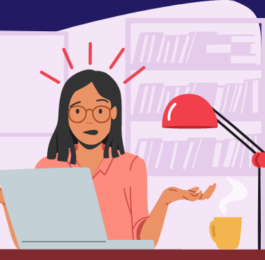 An assistant with red glasses looking confused. She's sitting at a desk with a laptop, a hot drink, and a red table lamp.