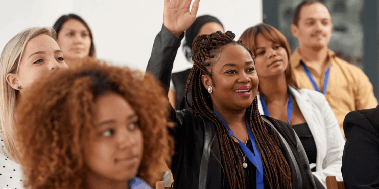 Woman raising her hand in a conference