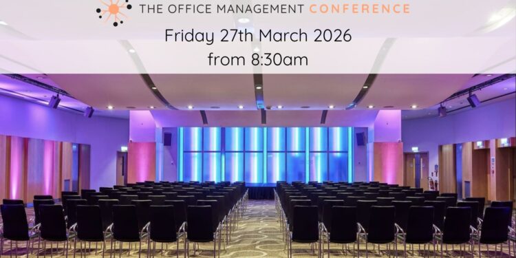 A photo of a empty conference hall filled with seats ready for office managers.