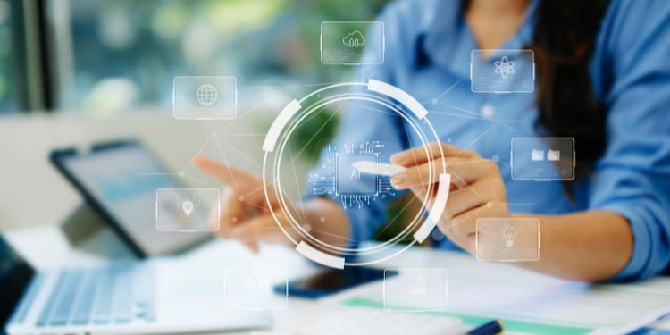 An administrative professional using a stylus on a holographic screen to work with AI representing the future of the role.